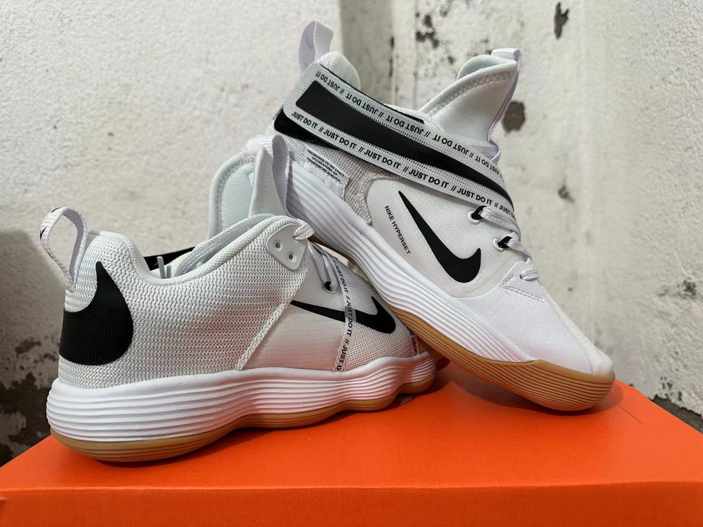 Pair of white Nike HyperBet basketball shoes with black accents and gum-colored outsoles.
