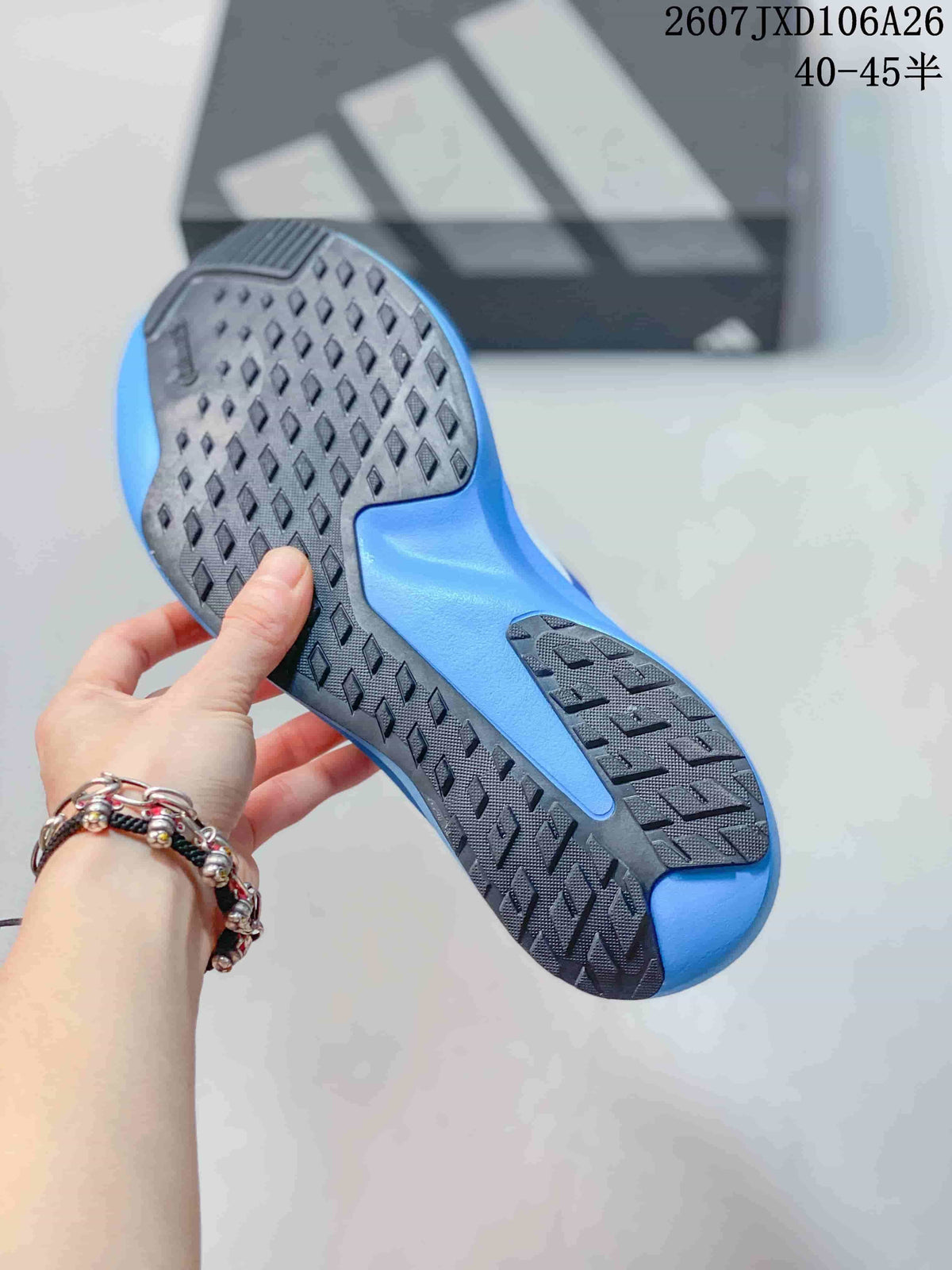 Bottom view of the blue and white sneaker showing the black rubber outsole with diamond-shaped traction details and blue midsole sections.