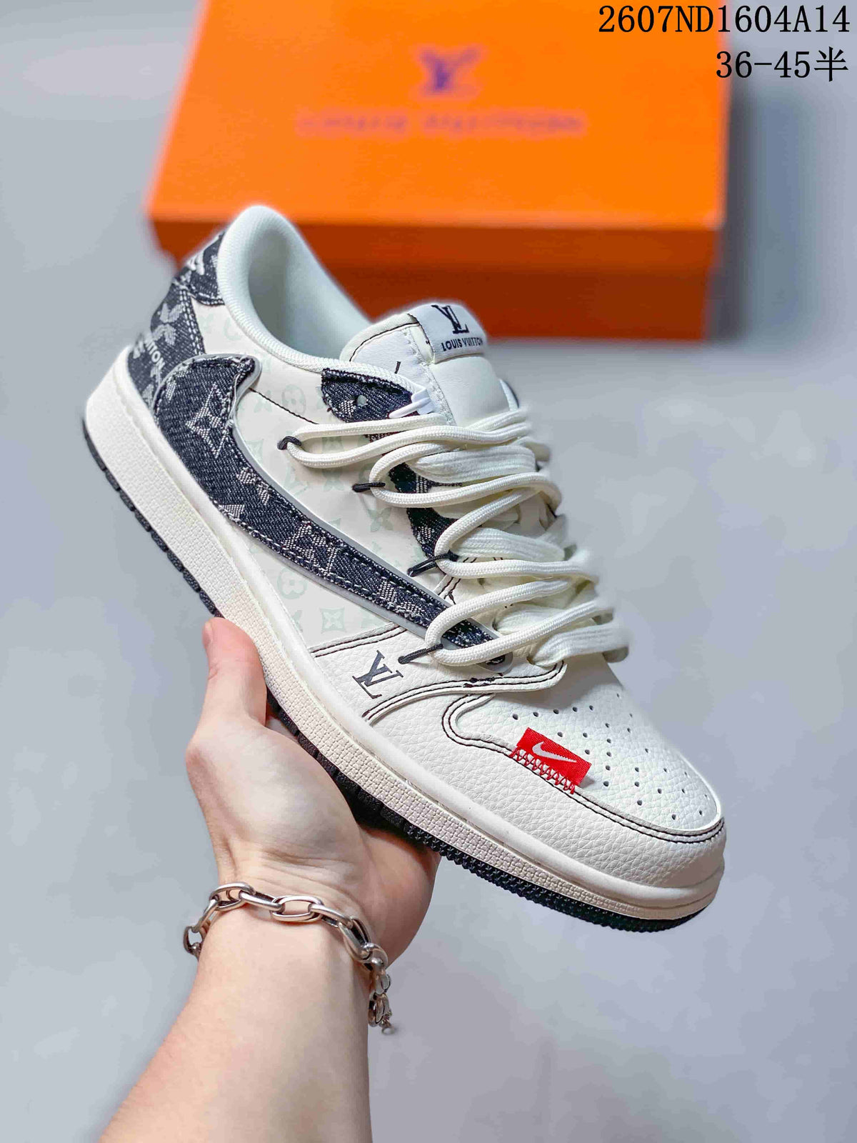 Angled side view of the sneaker highlighting the white upper, patterned dark panels, low-top shape, and dark outsole.