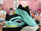 Pair of light aqua basketball shoes shown from the side and at an angle