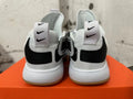 Rear view of white Nike basketball shoes with black heel details and gum-colored outsole edges.