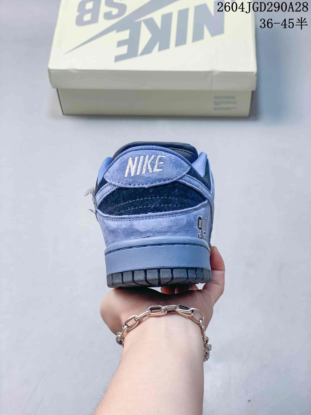 Rear view of a blue and dark navy Nike SB Dunk Low Pro sneaker
