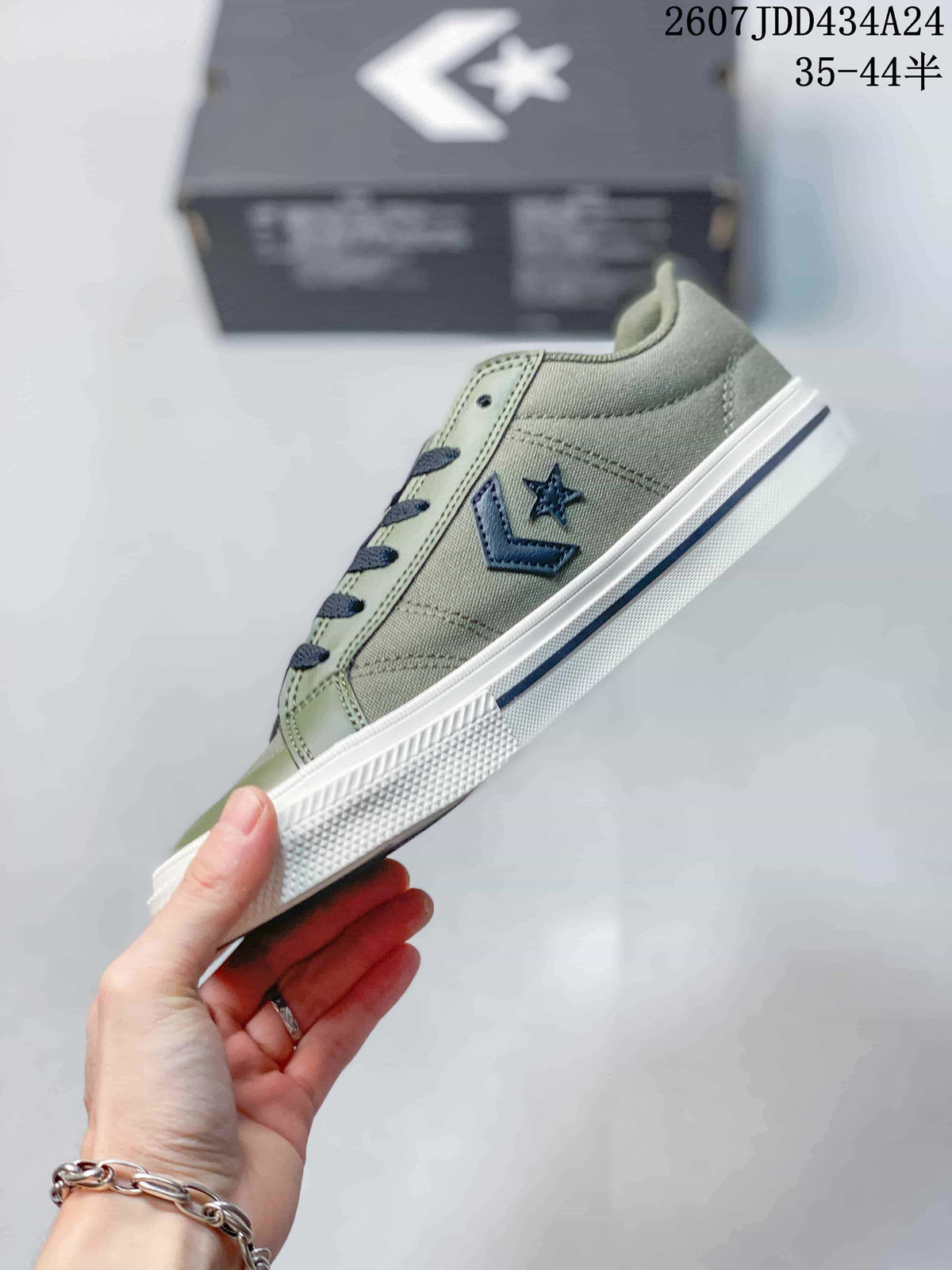 Side profile of the green low-top sneaker showing the dark side logo, stitched panels, white midsole, and dark stripe.