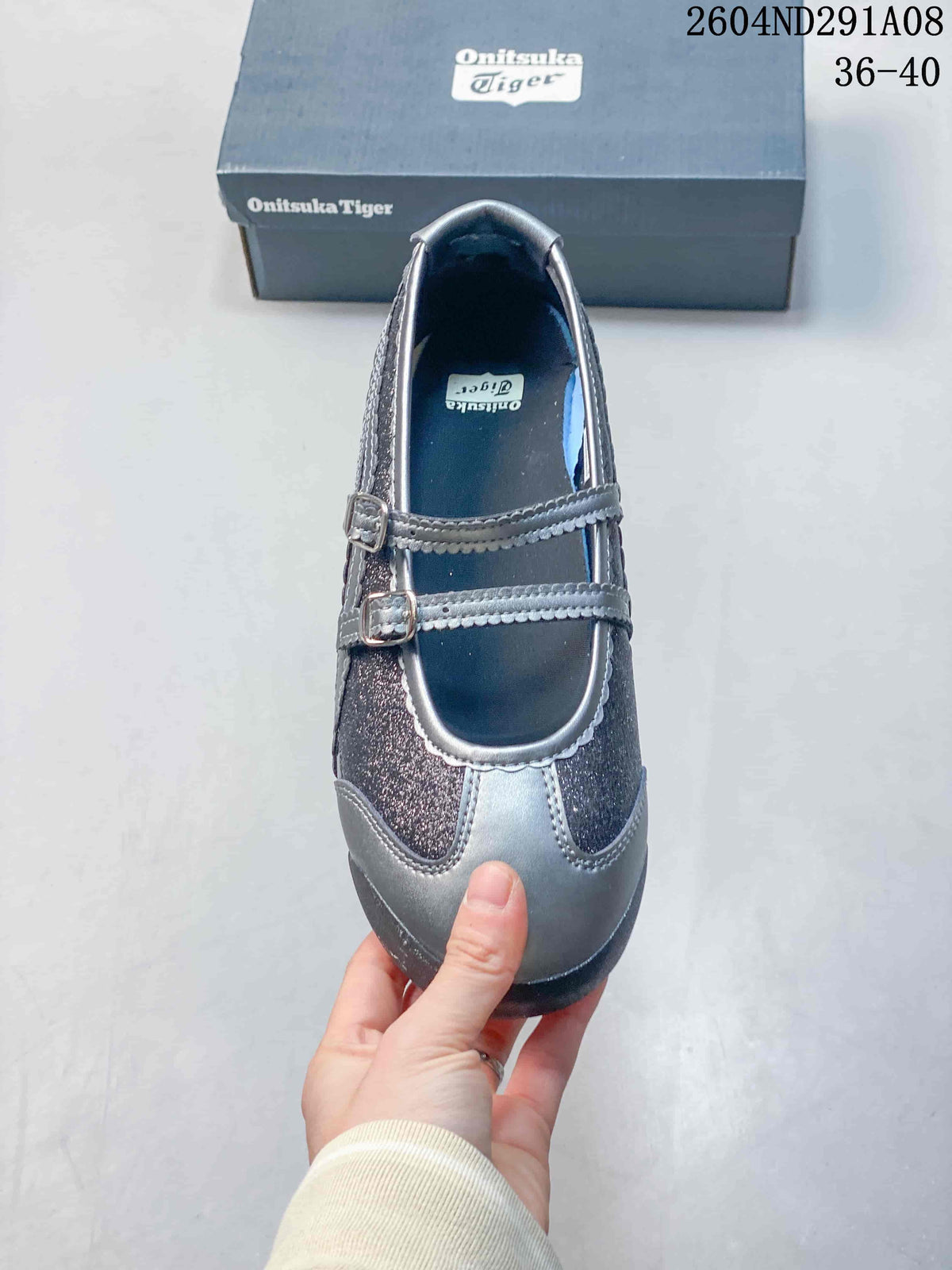 Top view showing the rounded toe, two buckle straps, gray trim, and dark glittered panels.