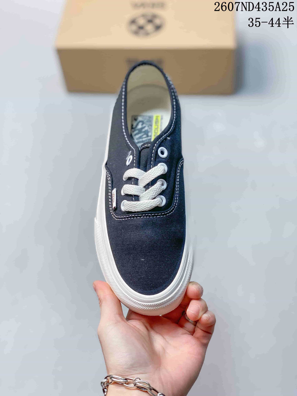 Top view of the navy sneaker showing the lace-up vamp, white laces, and rounded toe.