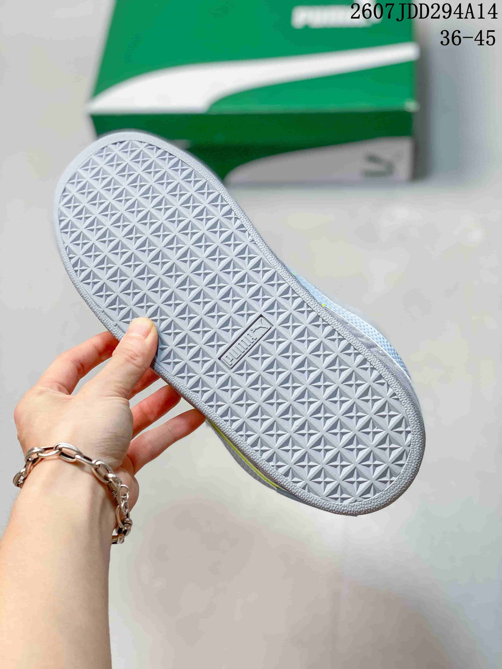 Close view of the light gray outsole showing its repeating geometric tread pattern; the image shows size range 36-45.