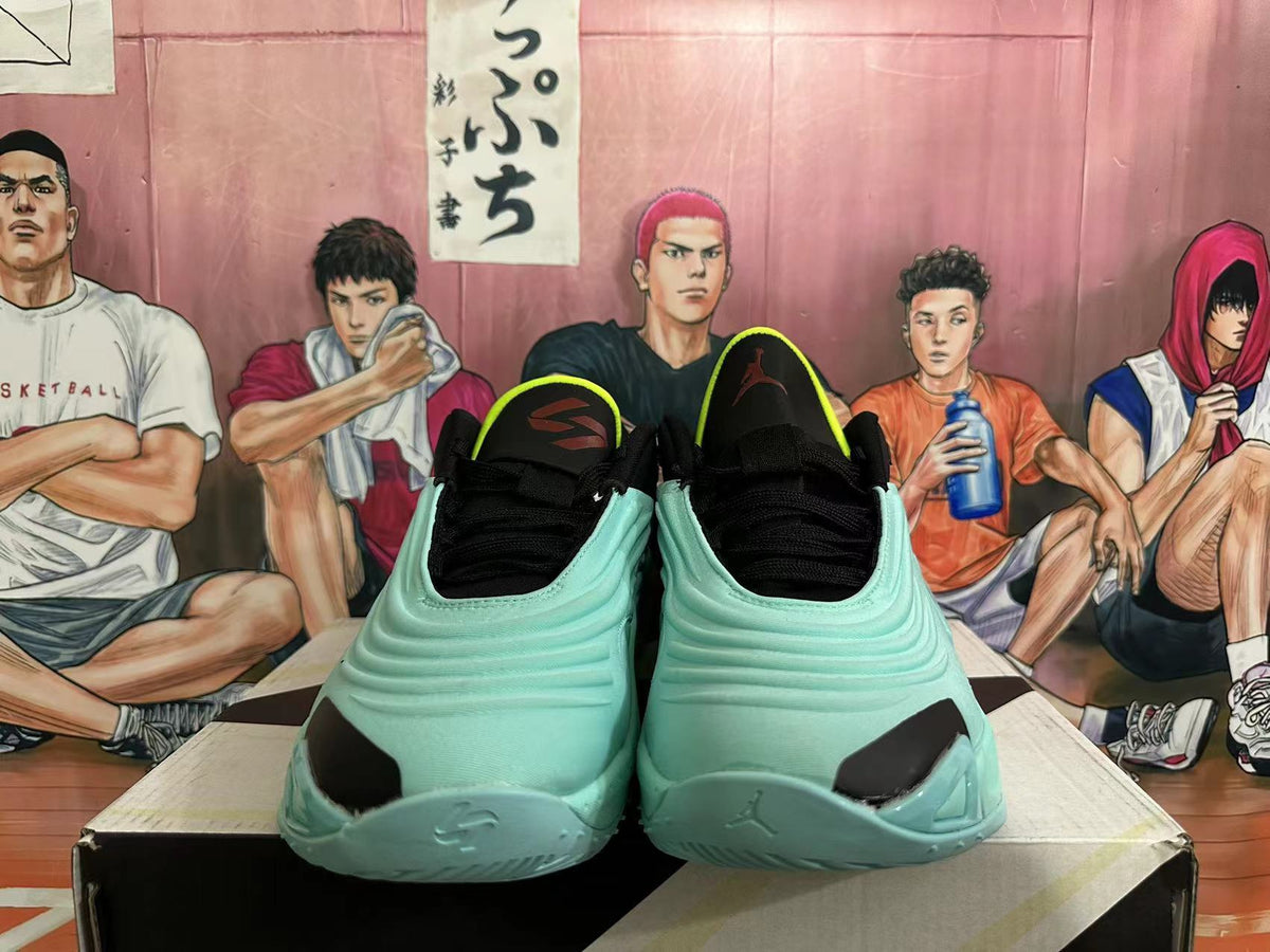 Front view of light aqua basketball shoes with black laces and bright volt accents