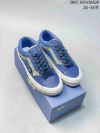 Pair of blue Vans Old Skool sneakers with multicolor side stripes displayed on a shoe box; image text shows style code 2607JGD436A26 and size range 35–44.5.
