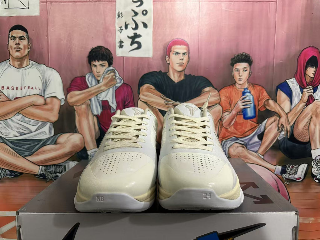 Front view of white Nike basketball sneakers with perforated toe boxes, tonal laces and visible tongue logos.