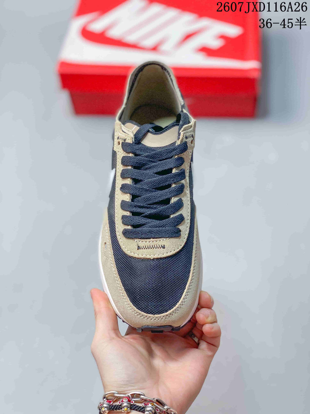 Top-down view showing the dark laces, brown eyelet panels, dark toe panel, and white midsole edge.