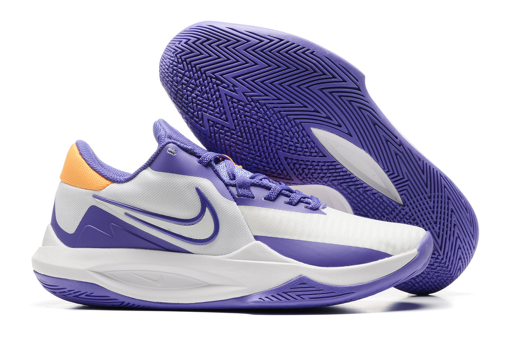 White and purple basketball shoe with orange heel details and a purple outsole.