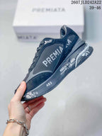 Side profile showing the metallic emblem, layered panels, printed midsole graphics, and raised heel section.