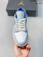 Top view showing the white perforated toe box, light blue overlays, white laces, and yellow tongue branding.