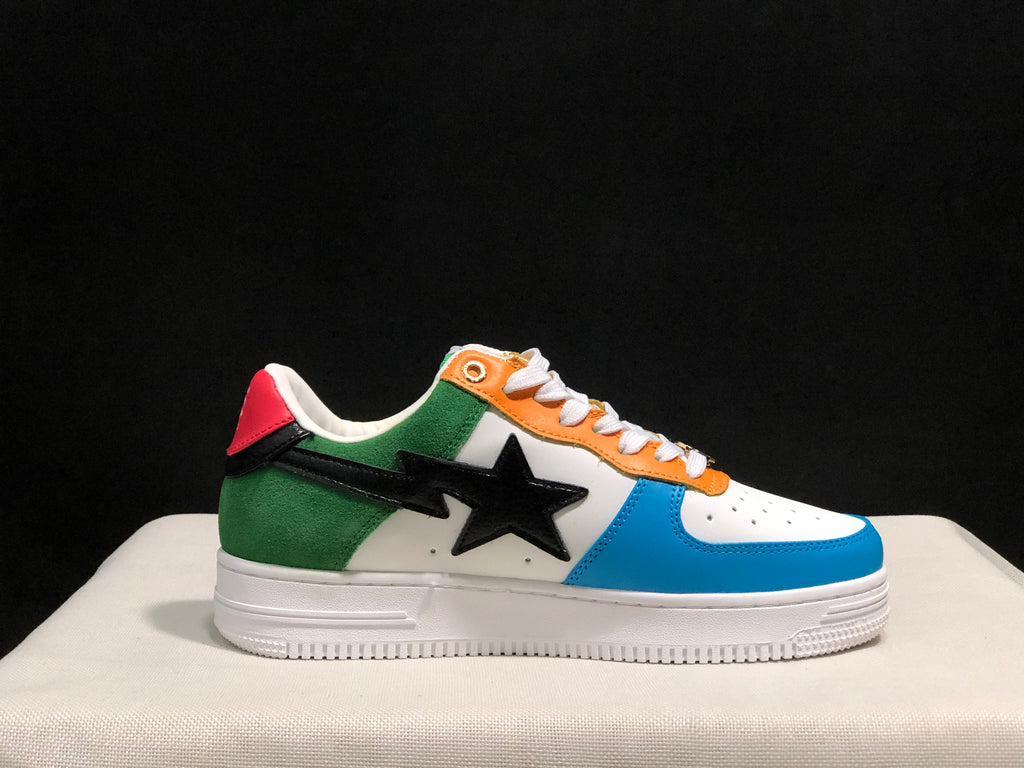 Side profile showing the green heel, orange eyelet panel, blue toe overlay, and black star detail.