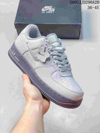 Pale gray and lavender low-top sneaker with a charm detail