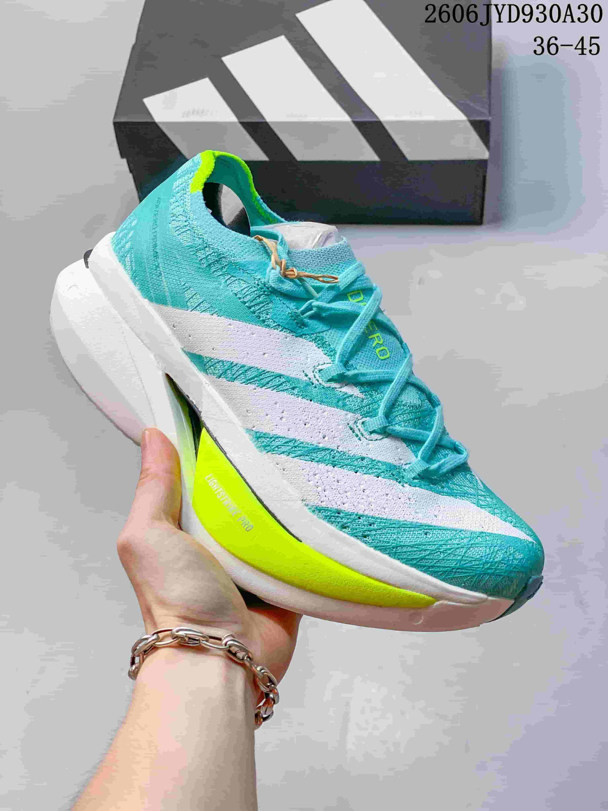 Turquoise adidas Adizero Prime X3 shoe with white side stripes and a neon yellow sole accent.