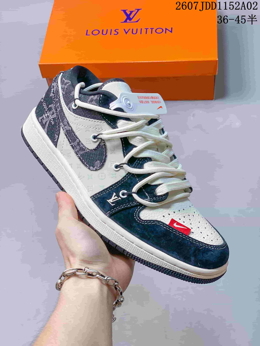 Side view of a white and navy low-top sneaker with patterned panels and a light sole.