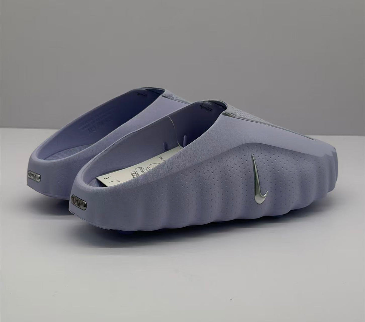 Rear three-quarter view showing the heel openings, side Swoosh, and heel branding details.