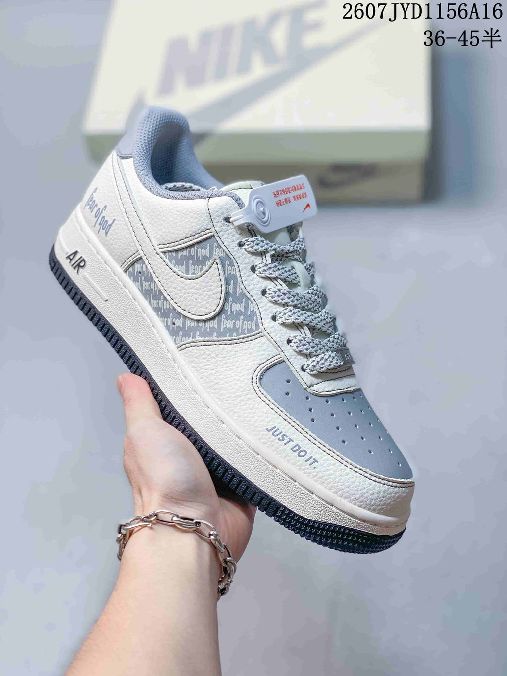 Close-up side view of a white and grey patterned sneaker with visible side graphics, perforated toe box, and Air sole branding.