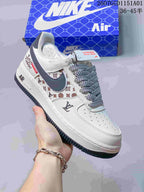 White and gray-blue Air Force 1-style sneaker with a dark Swoosh and patterned laces.