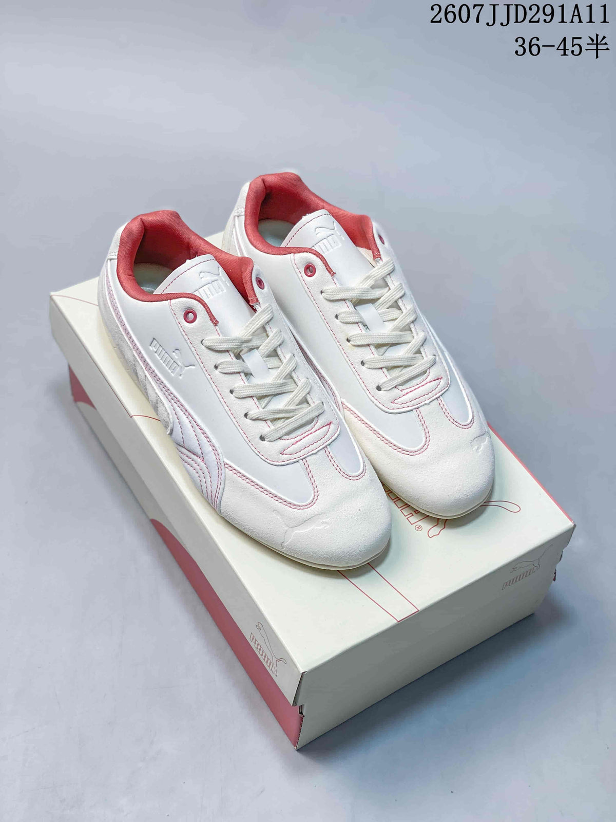 Pair of white and pink Puma low-top sneakers displayed on a Puma shoe box; image text shows style code 2607JJD291A11 and size range 36-45.