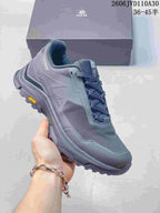Angled view of the gray shoes showing the side panels and outsole