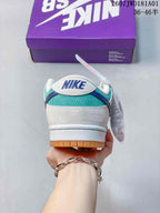 Rear view showing the teal heel panel, white overlays, and blue accent on a Nike SB Dunk Low Pro sneaker.