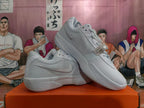 White Nike basketball shoes shown from the side and at an angle
