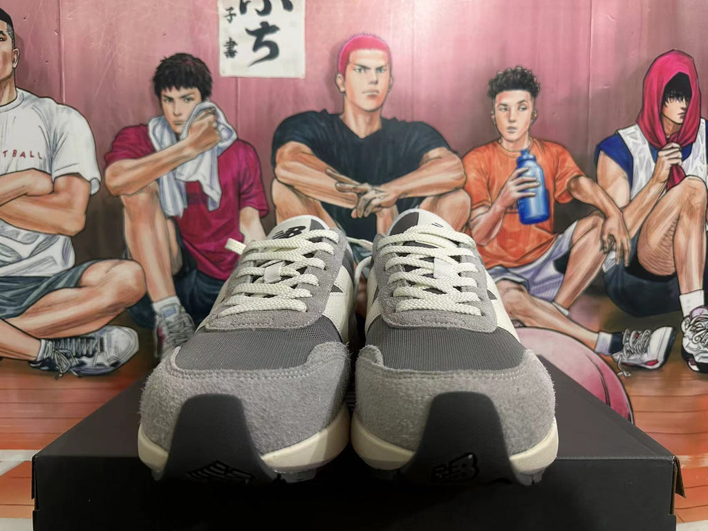 Front view of grey New Balance U370 sneakers with off-white laces