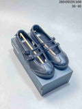 Pair of black Onitsuka Tiger Mary Jane-style sneakers displayed on a shoebox, with two buckle straps and a visible 36–40 size range.