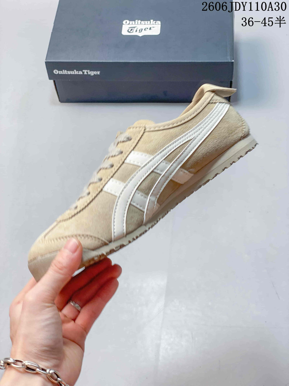 Side profile of a beige Onitsuka Tiger sneaker with white stripes