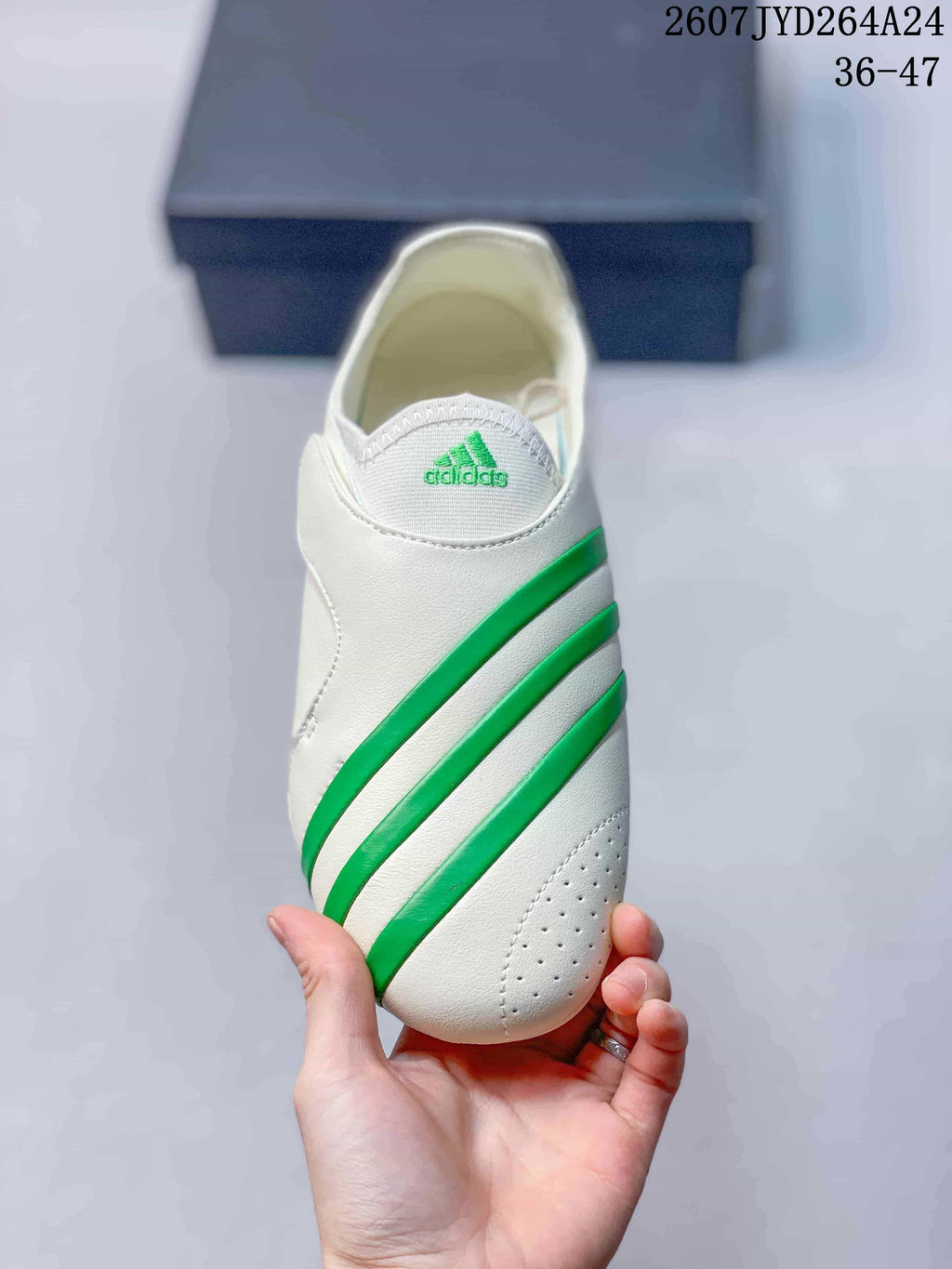 Top view showing the slip-on-style opening, green adidas tongue branding, and diagonal green stripes.