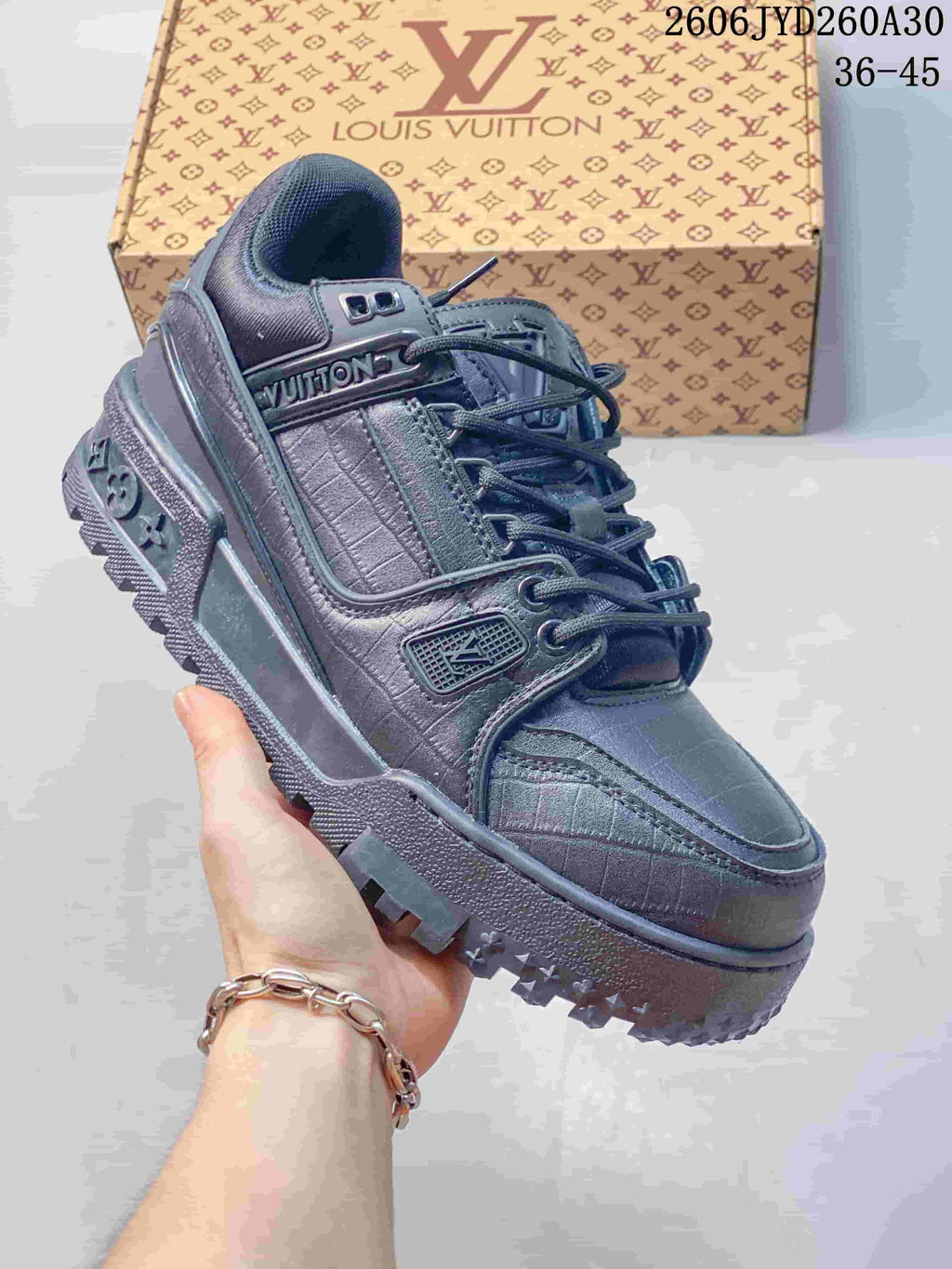 Dark metallic gray Louis Vuitton Trainer Maxi low-top sneaker with textured panels and dark laces.