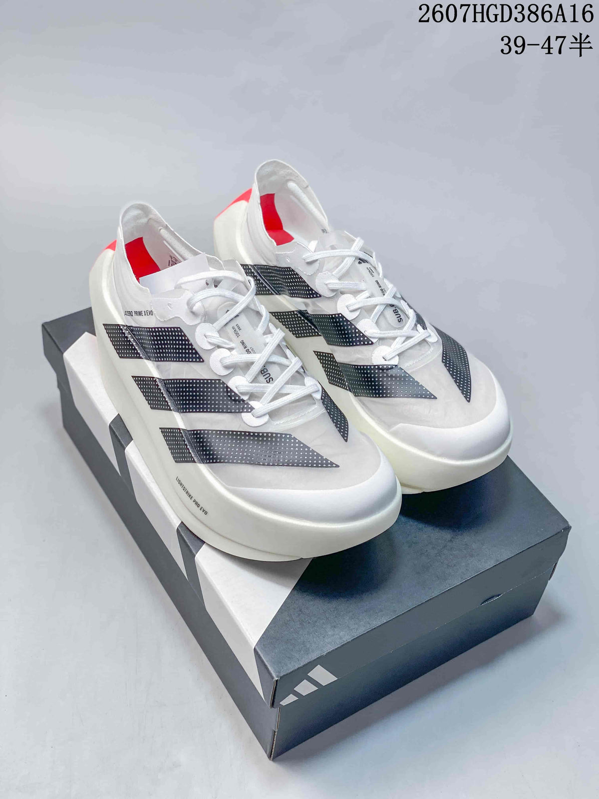 Pair of white adidas Adizero Prime X Evo shoes with black dotted stripes displayed on a shoebox.