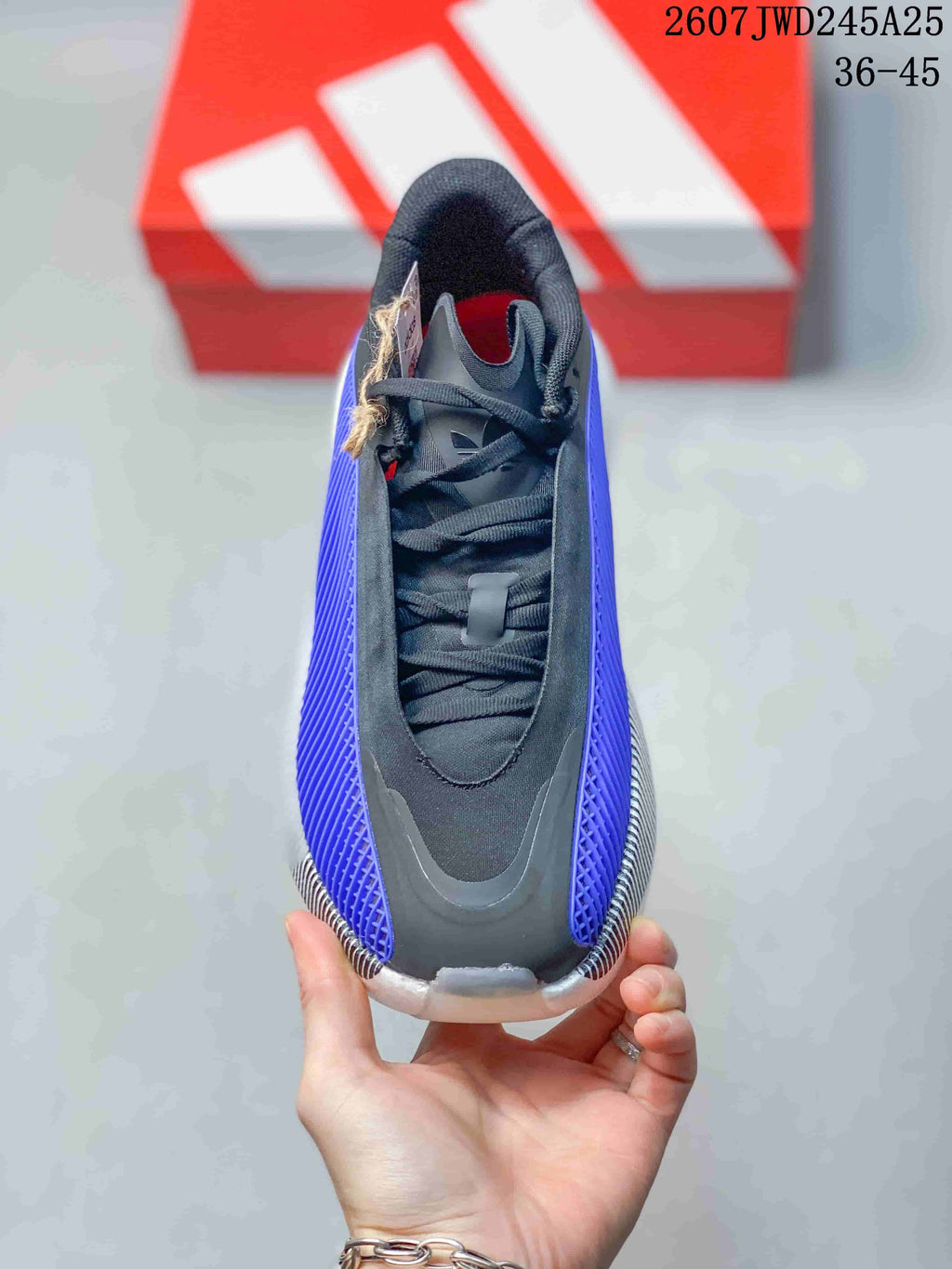 Top view of the sneaker showing black laces, tongue and purple side panels.