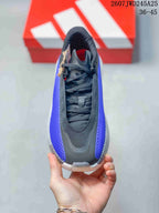 Top view of the sneaker showing black laces, tongue and purple side panels.