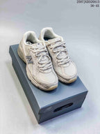Pair of cream New Balance 740 sneakers displayed on a branded shoe box; the image also shows the text 36-45.