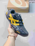 Close side view of a dark navy ASICS Hypersync sneaker with yellow side accents and a lace-up front.