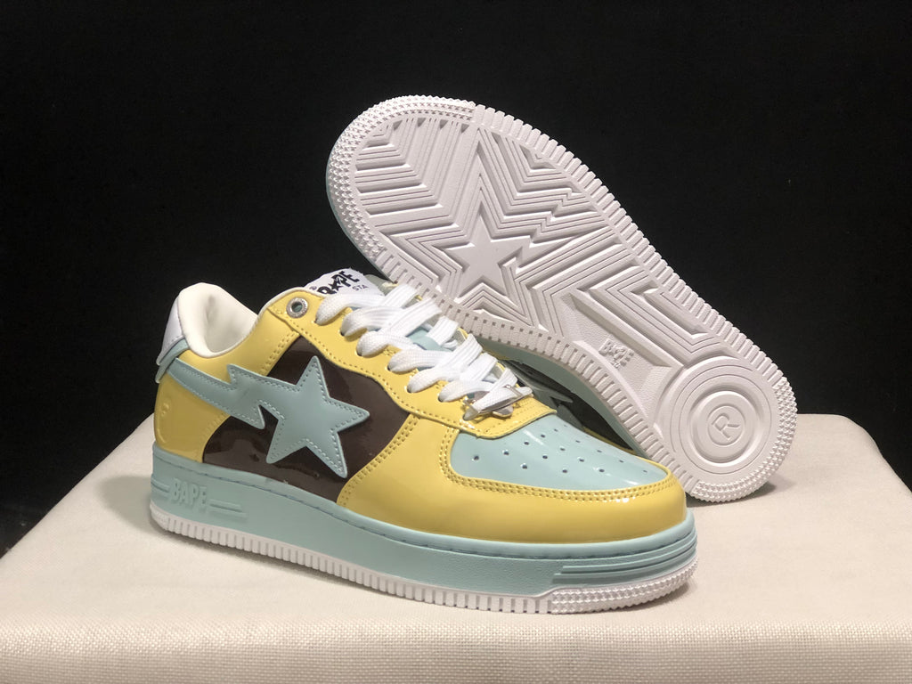 Angled view of a BAPE STA sneaker with the patterned rubber outsole visible beneath the second shoe.