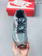 Top view showing the teal mesh toe box, silver overlays, black laces, and padded tongue.