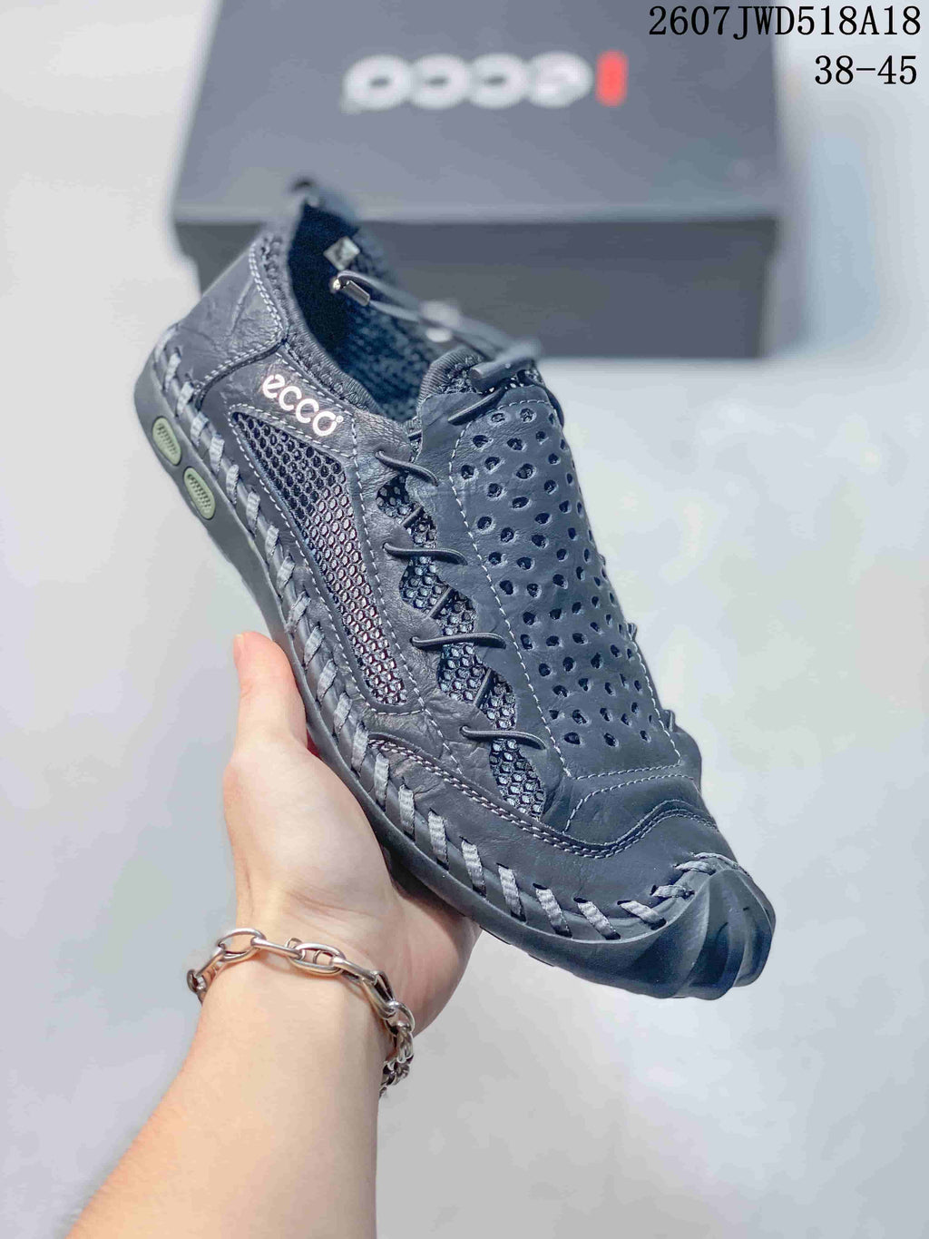 Three-quarter view of the black ECCO sneaker showing the branded side panel, perforated upper and reinforced toe.