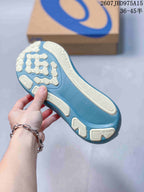 Close view of the blue-teal sneaker outsole showing segmented light-colored traction sections.