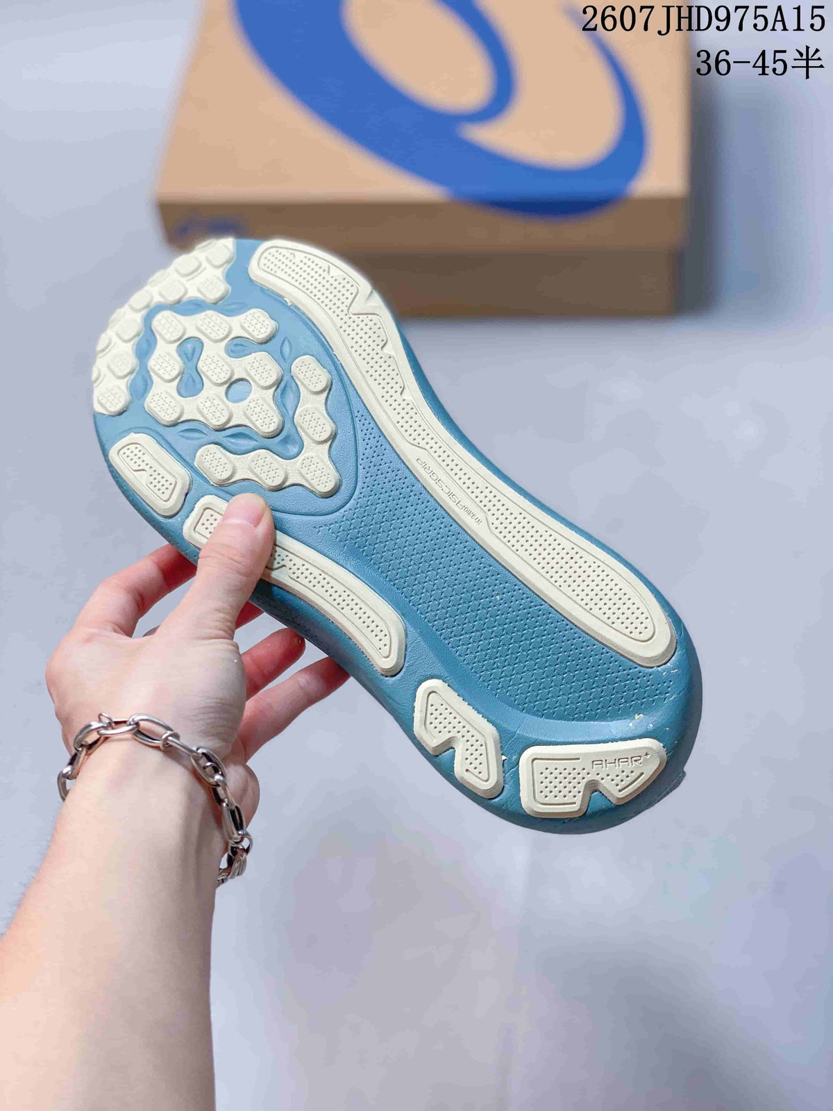 Close view of the blue-teal sneaker outsole showing segmented light-colored traction sections.