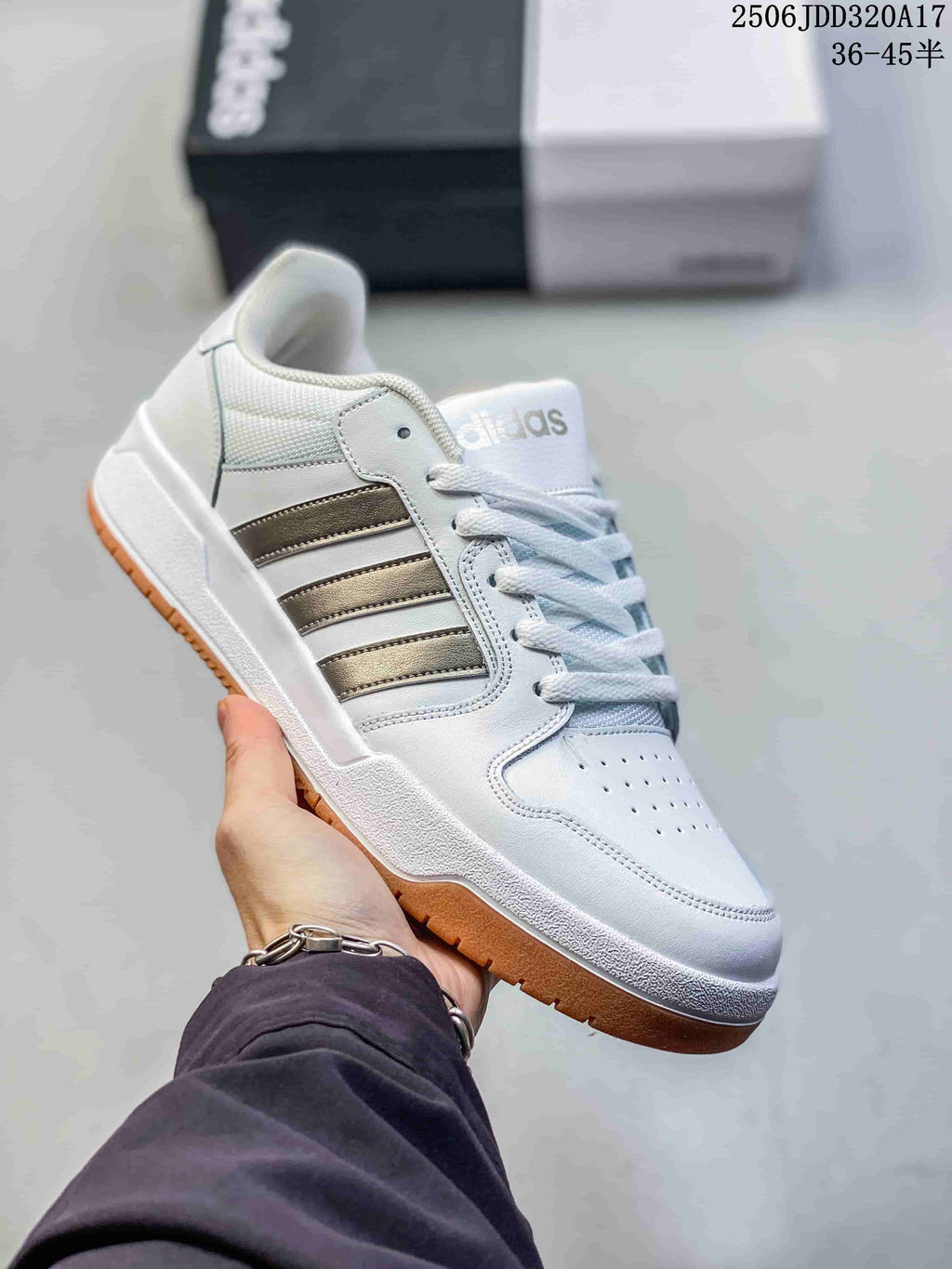 White adidas Entrap sneaker with muted gray side stripes and a gum-colored outsole.