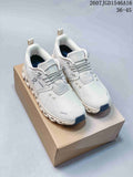 Pair of white and grey On sneakers displayed on a cardboard box, with the product code and size range visible at the top.