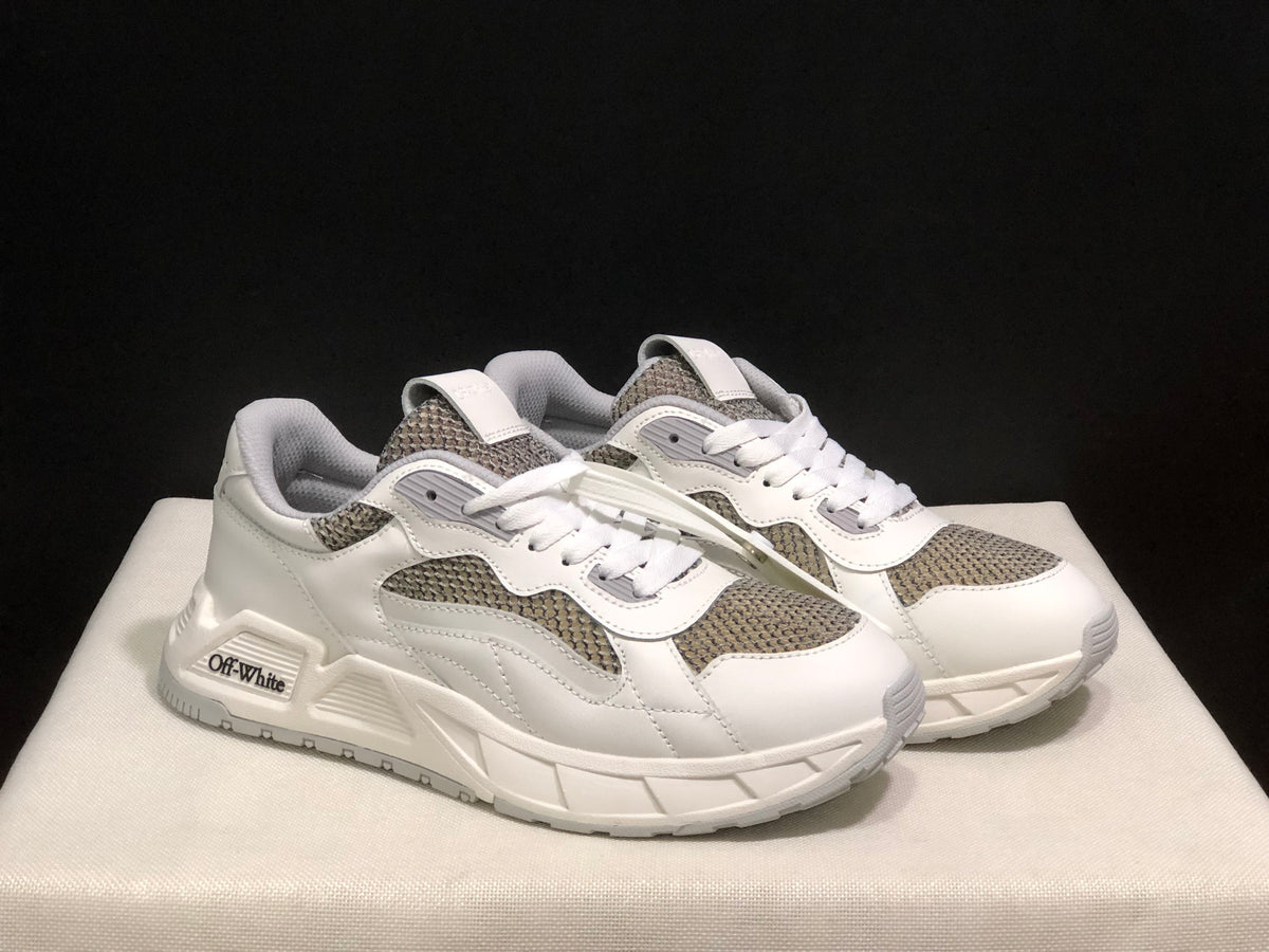 Three-quarter view of the pair highlighting the white layered upper and grey panels.