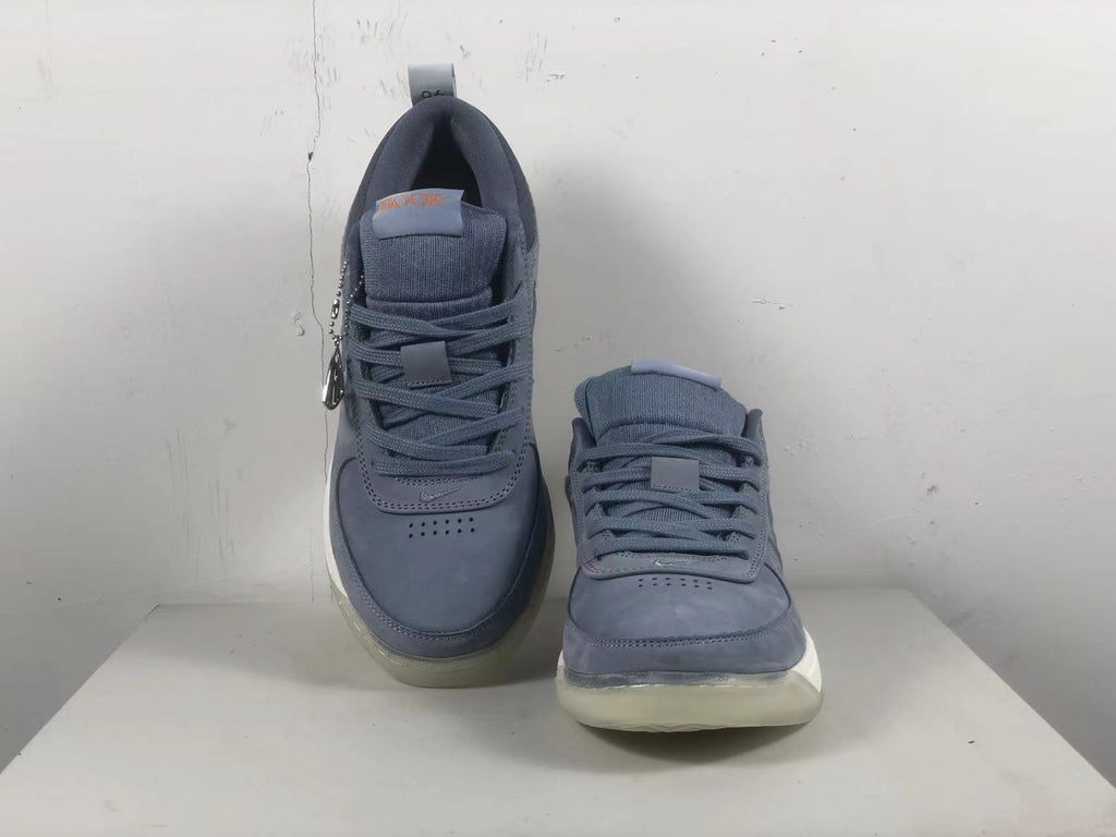 Top view of a pair of blue-gray Nike Book 1 shoes with laces and padded tongues.