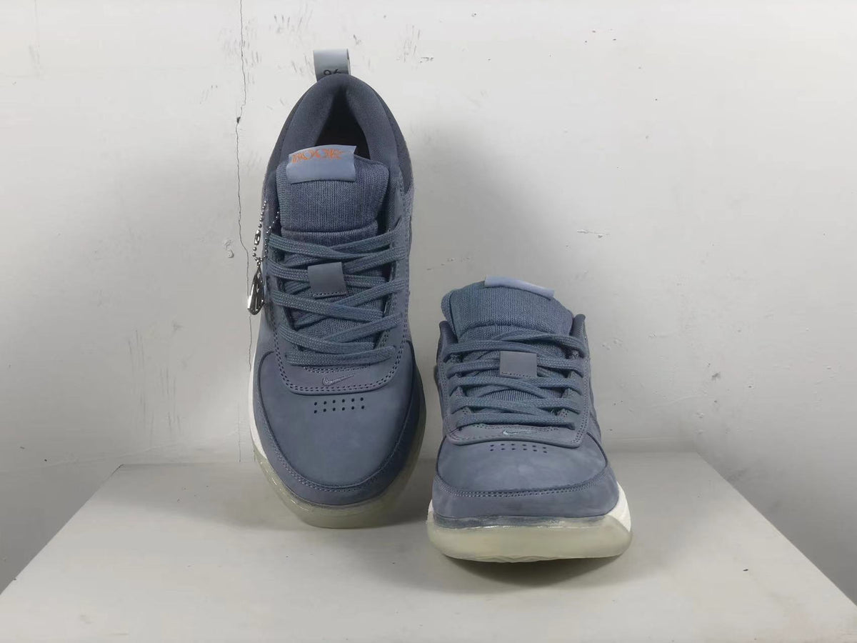 Top view of a pair of blue-gray Nike Book 1 shoes with laces and padded tongues.