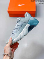 Side profile showing the lace-up upper, layered midsole, and blue heel section.