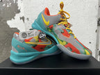 Pair of multicolor Nike basketball shoes with patterned uppers and turquoise soles